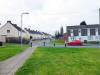 Later housing built on a green, with children playing on the road